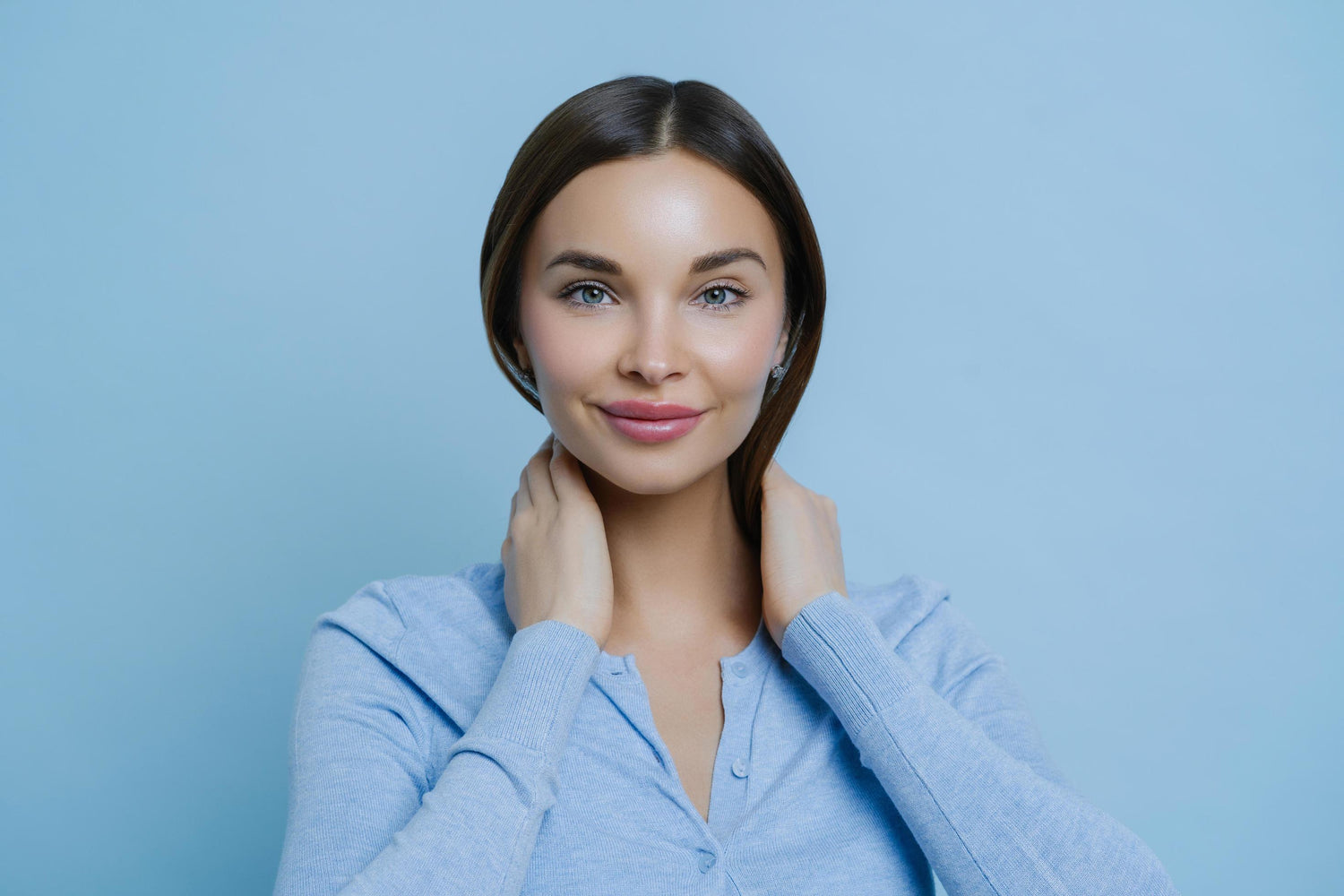 headshot-of-young-lovely-woman-keeps-hands-on-neck-has-european-appearance-happy-to-hear-pleasant-words-wears-casual-sweater-isolated-over-blue-background-human-face-expressions-conce_bf5e4a3a-1ca2-4258-bbf9-a4564bfbca05 @ Happytoys Sexshop: online sex shop for Feeling Happy & Easy 😊 the erotic store owned by a woman